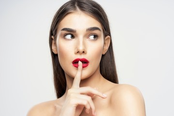 young woman with finger on her lips