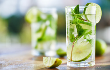 two mojito cocktails on wooden table top - obrazy, fototapety, plakaty