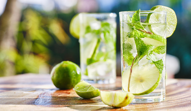 Two Mojito Cocktails On Wooden Table Top