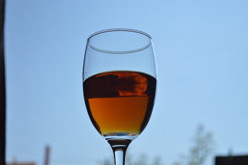 Brandy in wine glass and white background