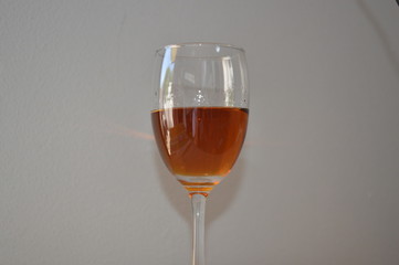 Brandy in wine glass and white background