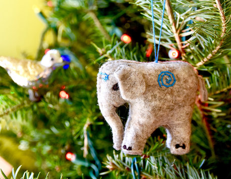 Elephant ornament hanging on a Christmas tree. Closeup.