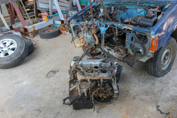The Old Car engine on crane hook in garage repair service, outdoor.