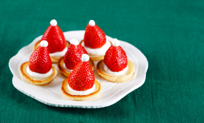 Santa Claus pancakes with whipped cream and strawberries, Christmas food idea