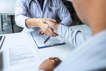 Doctor having shaking hands to congrats with patient after recommend sickness treatment while discussing explaining his symptoms and counsel diagnosis health, healthcare and assistance concept
