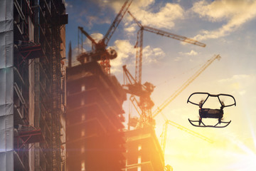 Drone flying over of the Construction site in cloudy sunset sky.