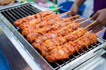 Raw Grilled pork skewers focus selective