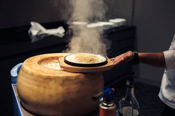 hand chef cooking with cheese and spaghetti.