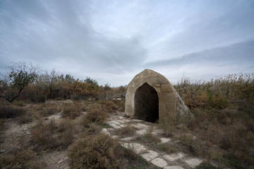 Fototapeta na wymiar Old abandoned well in the courtyard of the caravanserai, located in Azerbaijan