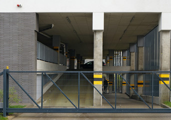 Steel gate to a two-level auto garage in the lower floors of a modern city building