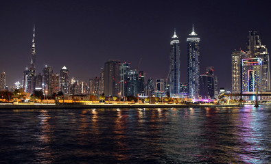 Fototapeta na wymiar High skyscrapers of the business city centers, located near the seaport panoramic dubai