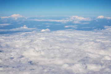 Aerial view of fluffy clouds. Top view of a beautiful cloudscape and blue sky