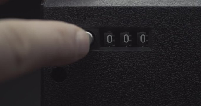 Finger pressing tape counter reset button and returning to 000