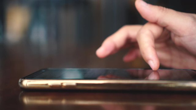 4k video People hand using smartphone with blur cafe shop background. Business, financial, trade stock maket and social network concept.