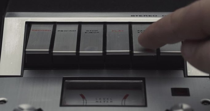 Press fast forward button on retro audio cassette tape player recorder