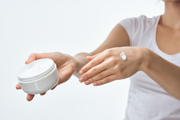 woman applying cream on her face