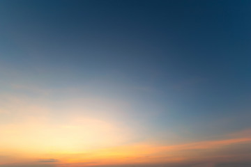 Sky blue and orange light of the sun through the clouds in the sky