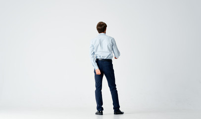 businessman standing in front of brick wall