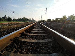 Low angle railway scenery with clean sky background. Metal sleepers on the railway, Railroad track