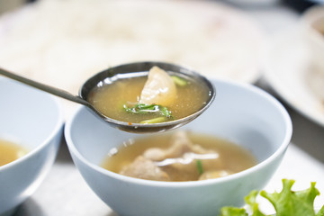 Scoop boiled zoop cartilage with a ladle.