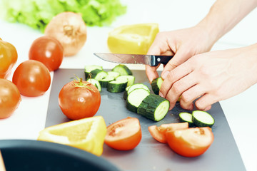 woman cutting vegetables in kitchen