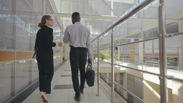 Business people walking in the office corridor