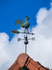 Weathercock at the top of a roof © E.Richard