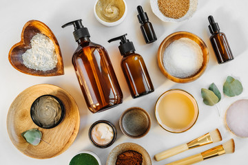Beauty treatment ingredients for making homemade skin care cosmetic mask. Various bowl with clay,...