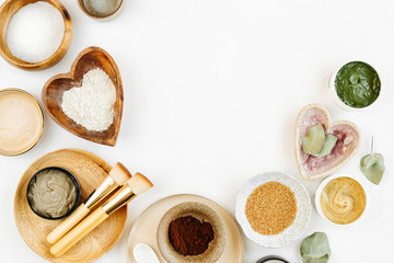Beauty treatment ingredients for making homemade skin care cosmetic mask. Various bowl with clay, cream, essential oil and natural ingredients  on white table background. Organic spa cosmetic products