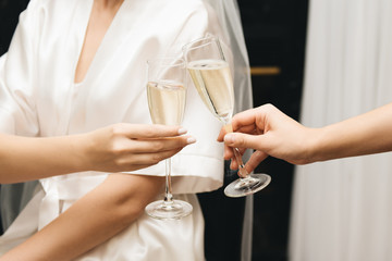 The details of the wedding day. Bride with girlfriends with glasses