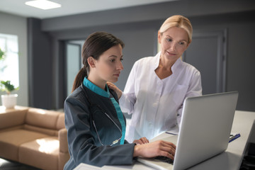 Senior doctor explaining work details to young intern