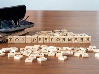top performers the word or concept represented by wooden letter tiles