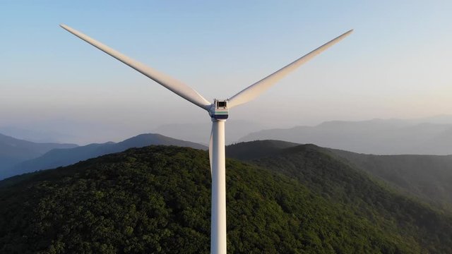 Drone shots of wind generators on top of a mountain