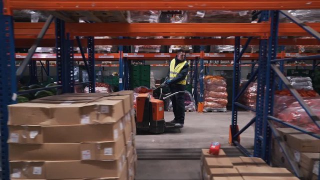 workers moves on a forklift in a warehouse