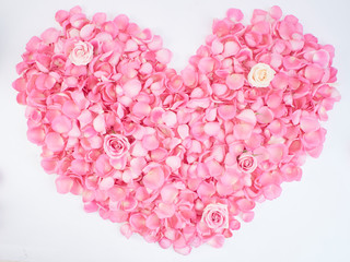 Heart symbol made of pink rose petals.