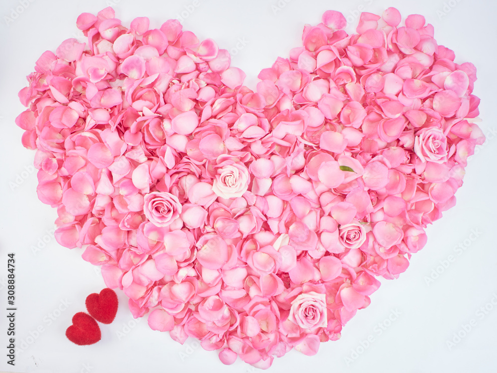 Wall mural heart symbol made of pink rose petals.