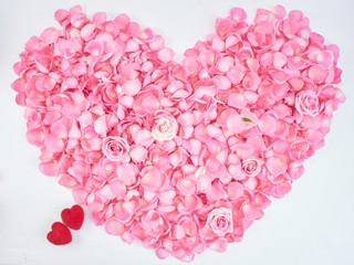 Heart symbol made of pink rose petals.