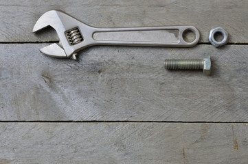 flatlay.adjustable wrench and bolt on a wooden background. copy space.
