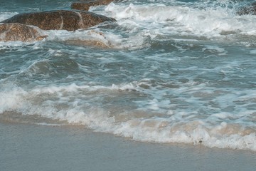 Sea wave with stone on the Hua Hin beach, Prachuap Khiri Khan, Thailand. Pastel tone.