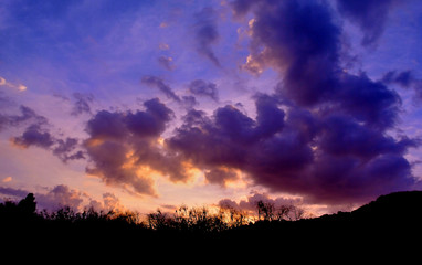 Dramatic twilight sky with silhouette landscape