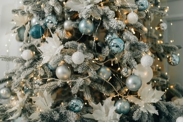 Beautiful holdiay decorated room with Christmas tree with presents under it. Interior with Christmas tree in pastel colors.