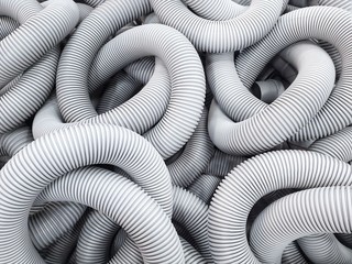 Plastic pipe background.White curled plastic tubes.Tubing pvc flexible use water drainage or...