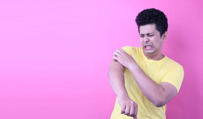 Portrait Handsome Asia man feel very itchy arm on pink background in studio With copy space.