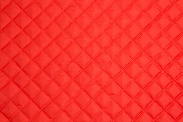 Poster Quilted fabric. The texture of the blanket. Red textile © fizke7