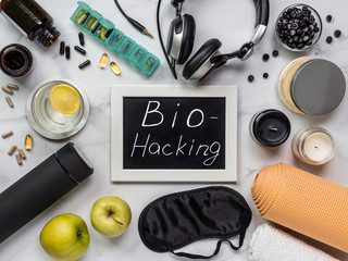 Biohacking flat lay concept. Top-down view of still life and word Bio Hacking on chalkboard