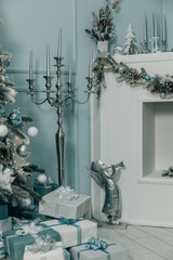 Beautiful holdiay decorated room with Christmas tree with presents under it. Interior with Christmas tree in pastel colors.