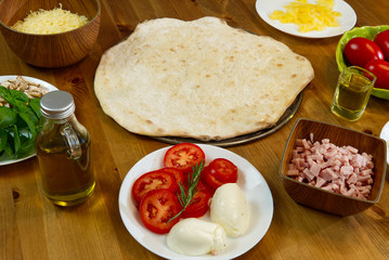 homemade pizza. ingredients, pizza base, tomato sauce. pizza in italy style