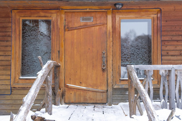 Russian wooden bath in winter. The fallen white snow lies on the ground.