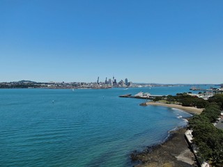 Naklejka na ściany i meble Devonport, Auckland / New Zealand - December 11, 2019: The Victorian Style Seaside Village of Devonport, with the skyline of Auckland’s landmarks and CBD in the background