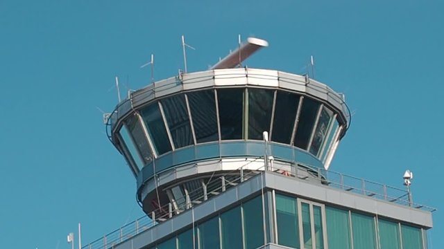 Airport. Close up air traffic control tower. Monitoring of departure and landing airplanes.